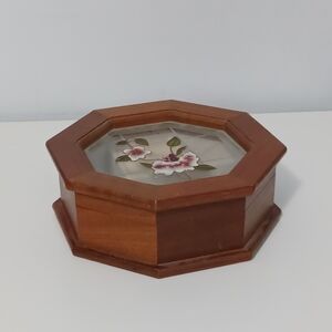 Wooden jewelry box with a glass lid decorated with painted flowers.